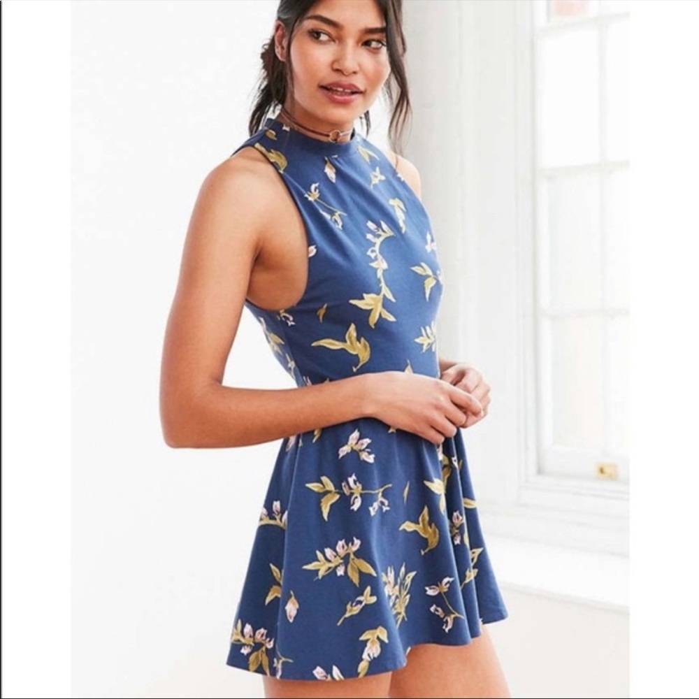 Navy romper with pink and mustard/green flower pattern.